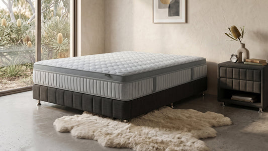 Grey quilted mattress on black bed base in neutral bedroom
