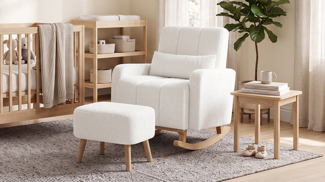 White bouclé rocking chair with matching ottoman and a lumbar cushion next to a wooden side table in a nursery.