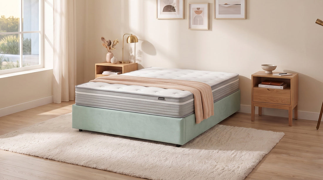 Grey mattress with white topper on mint bed base in bright bedroom