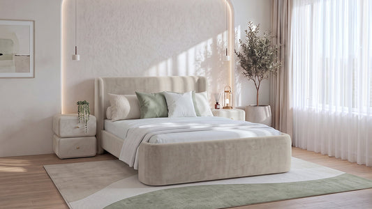 Cream upholstered bed with sage cushions in bright neutral bedroom