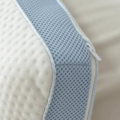 Extreme close-up of the pillow's blue mesh gusset side panel and zip pull