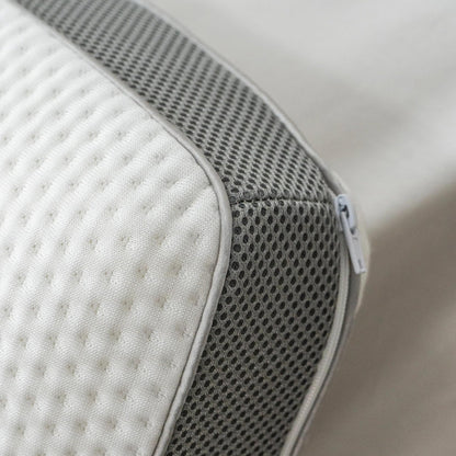 Extreme close-up of the pillow's grey mesh gusset side panel and zip pull