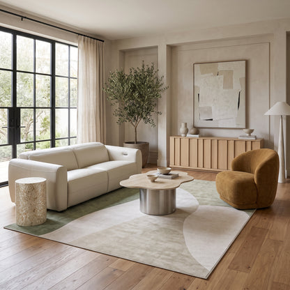 Cream leather sofa paired with a wavy sintered stone top coffee table, a mustard gold bouclé armchair, and a light timber sideboard in a bright living room setting.