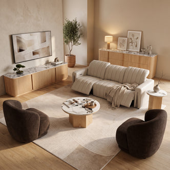 Cream leather recliner sofa with headrests extended, paired with two brown armchairs, a marble coffee table, and a matching sideboard in a modern living room setting.