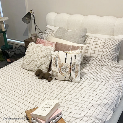 Aina King Boucle Bed Frame in Cream White with scalloped tufted headboard and grid-patterned bedding
