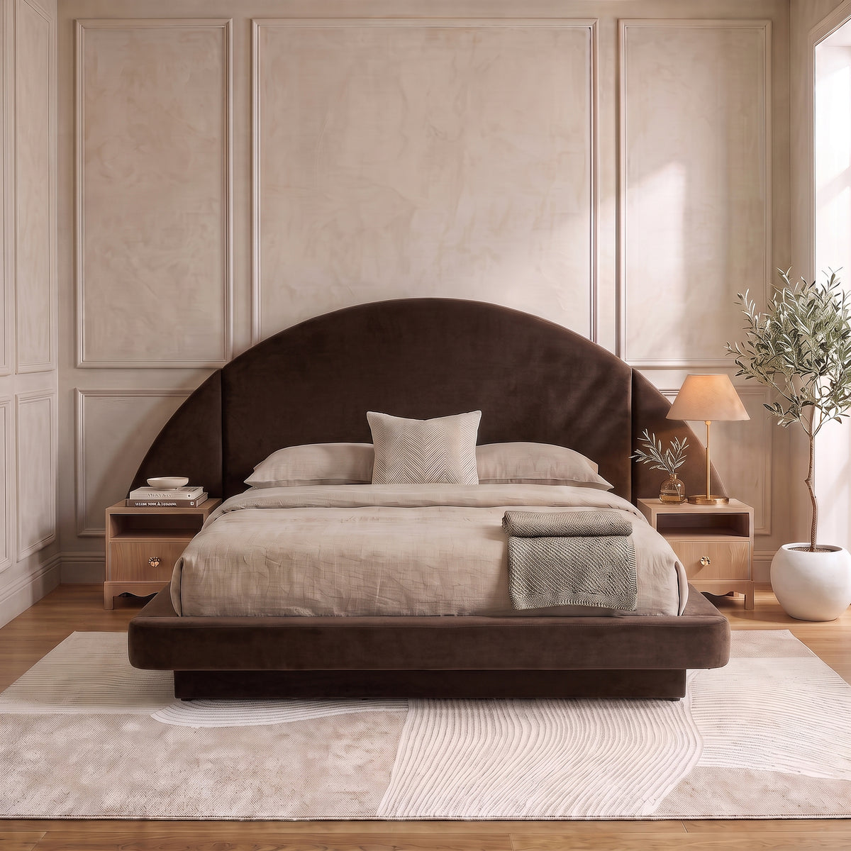 A modern neutral bedroom showcasing a dark brown velvet bed frame with an oversized half-moon headboard, styled with beige bedding and wooden nightstands on a textured abstract rug.