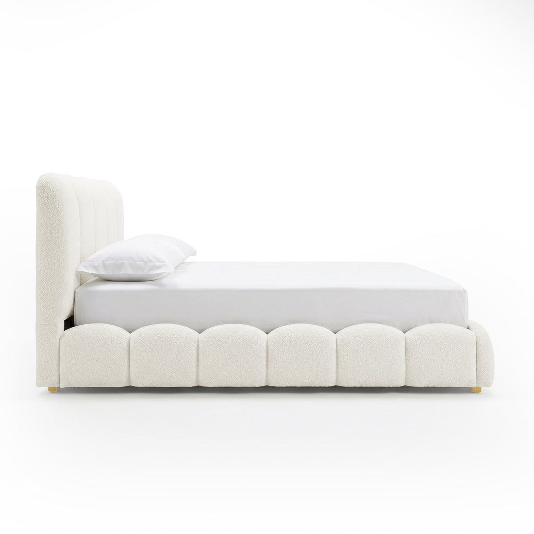 Brent double gas lift bed with scalloped base, boucle cream white upholstery, curved headboard, brass feet, white bedding