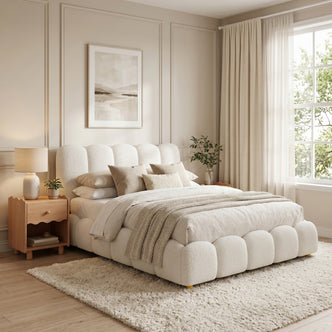 Brent Double Gas Lift Bed in Boucle Cream White with scalloped headboard and footboard, shown with bedding and throw rug