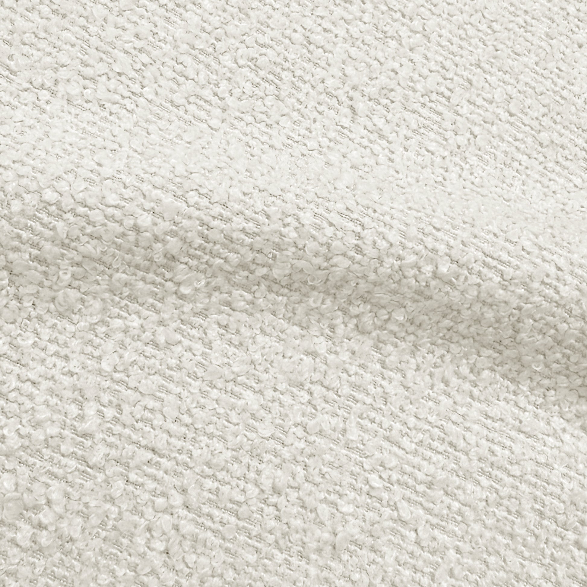 Close-up of cream white bouclé fabric upholstery showing textured weave detail