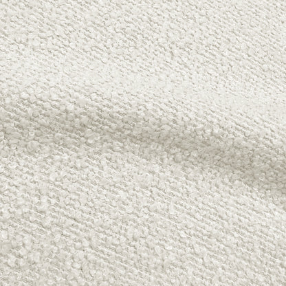 Close-up of cream white bouclé fabric upholstery showing textured weave detail