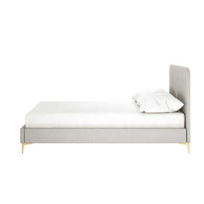 Grey upholstered bed frame with curved headboard, white mattress and pillow, gold tapered legs, side view