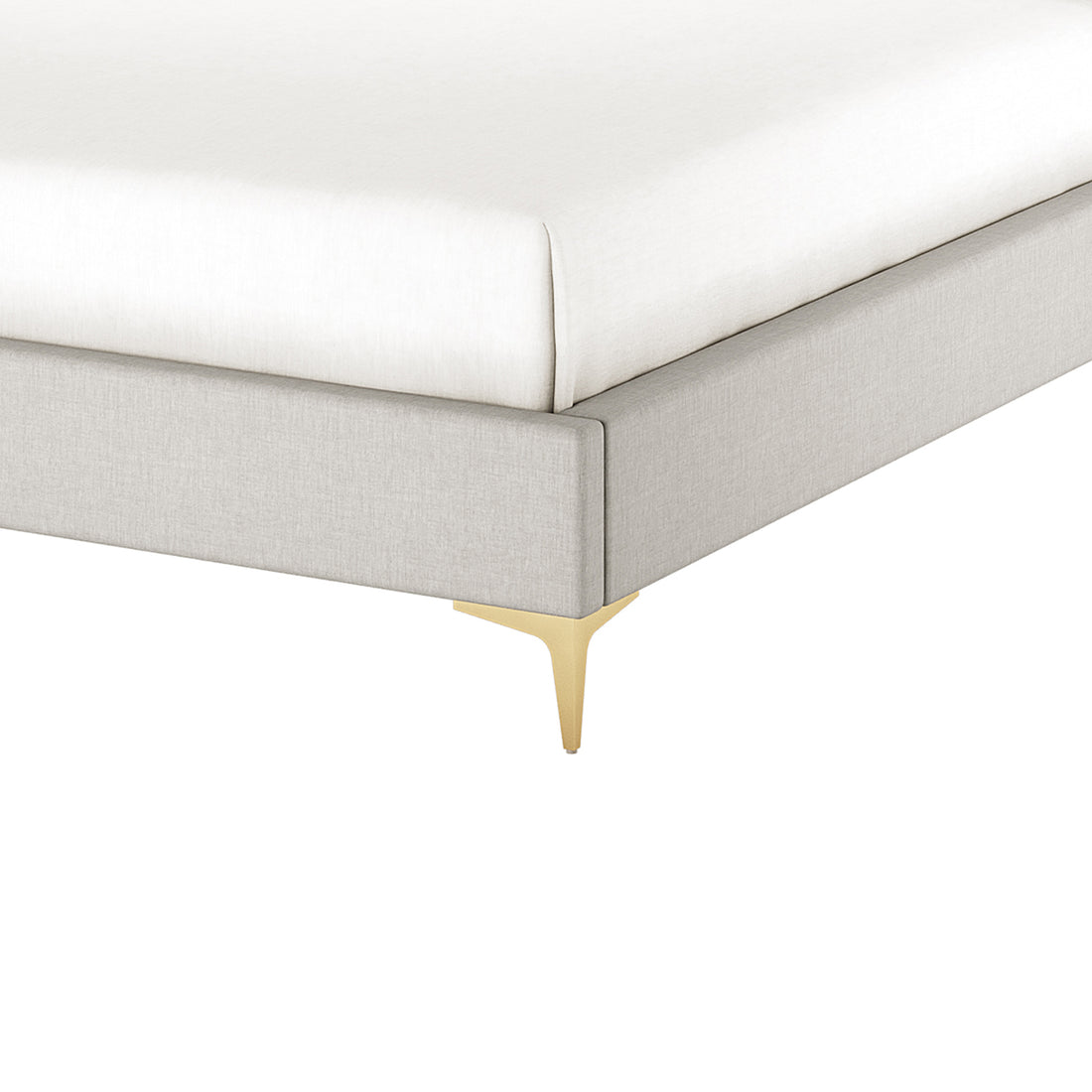 Corner detail of grey fabric bed frame with brass leg, white mattress