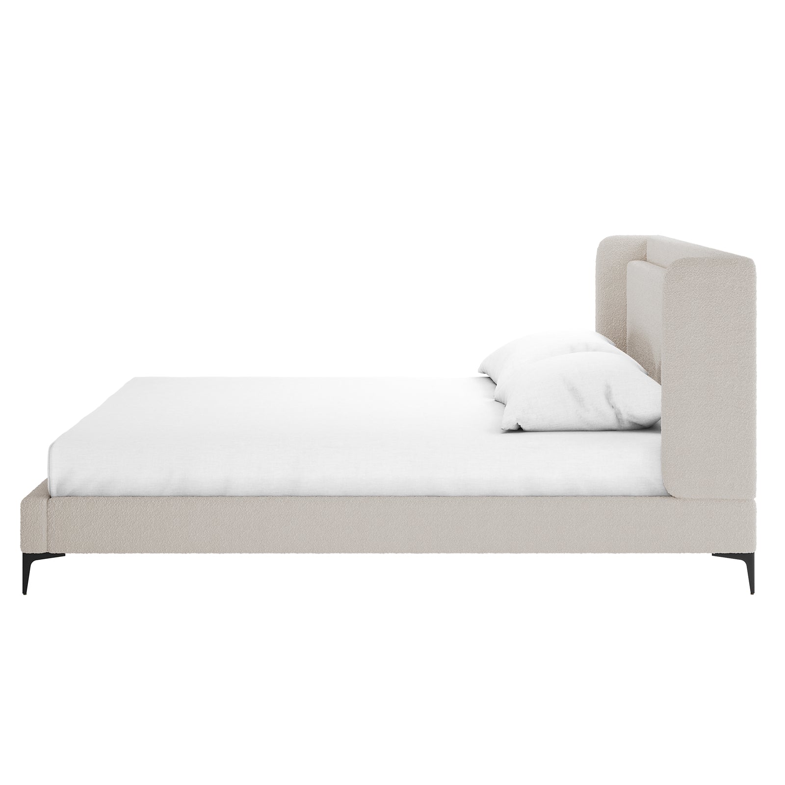 Beige boucle king bed frame with winged headboard, white mattress and pillow, black metal legs, side view