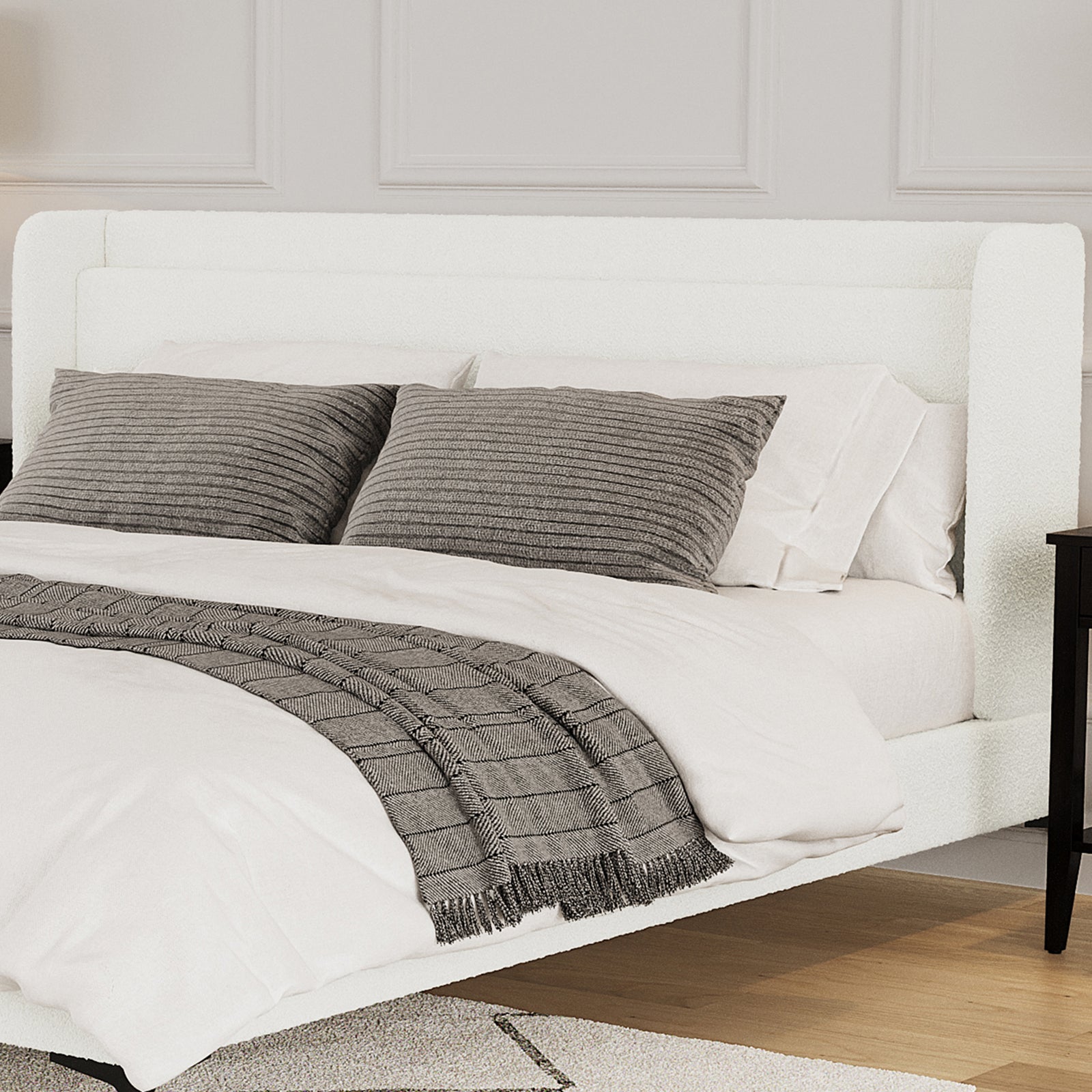 Cream white boucle king bed frame with winged headboard, styled with white bedding, grey textured cushions and throw