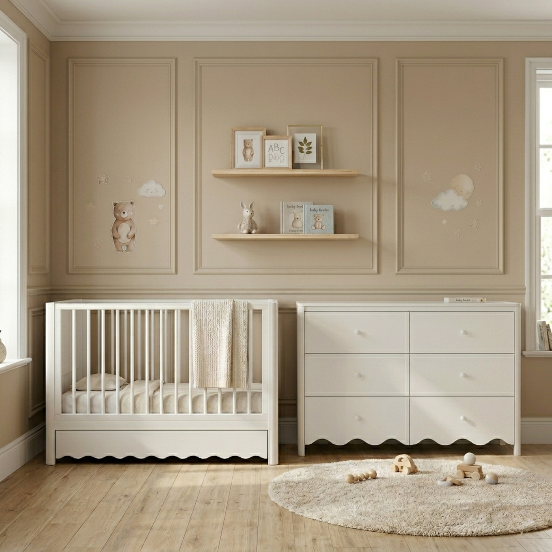 White timber baby cot with scalloped base and under-bed storage drawer, shown in nursery with matching chest of drawers