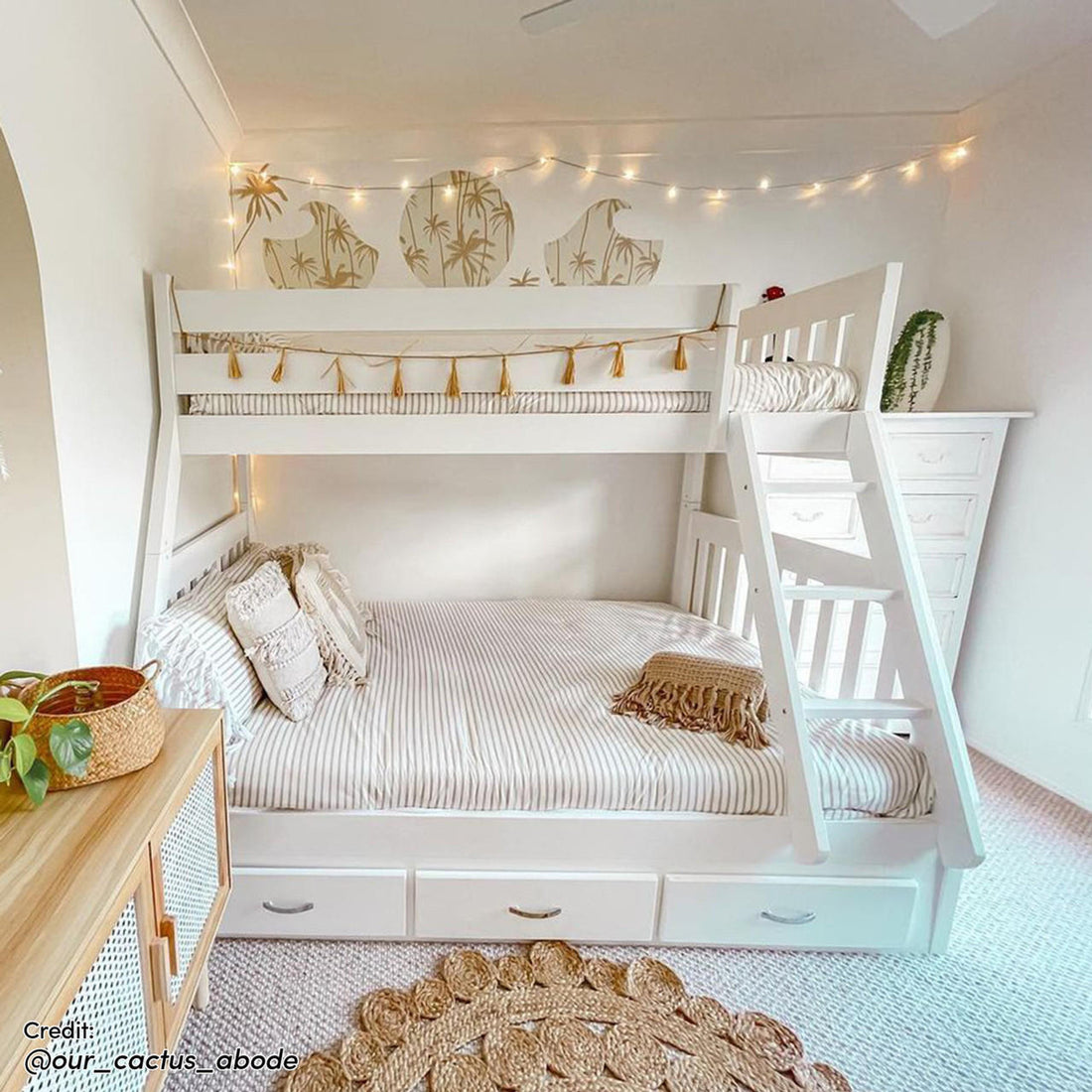 Cornelia Storage Triple Bunk Bed - White Solid Wood: A sleek triple bunk bed with guard rails, a solid ladder, and three under-bed drawers, providing practical storage in a compact, stylish design.