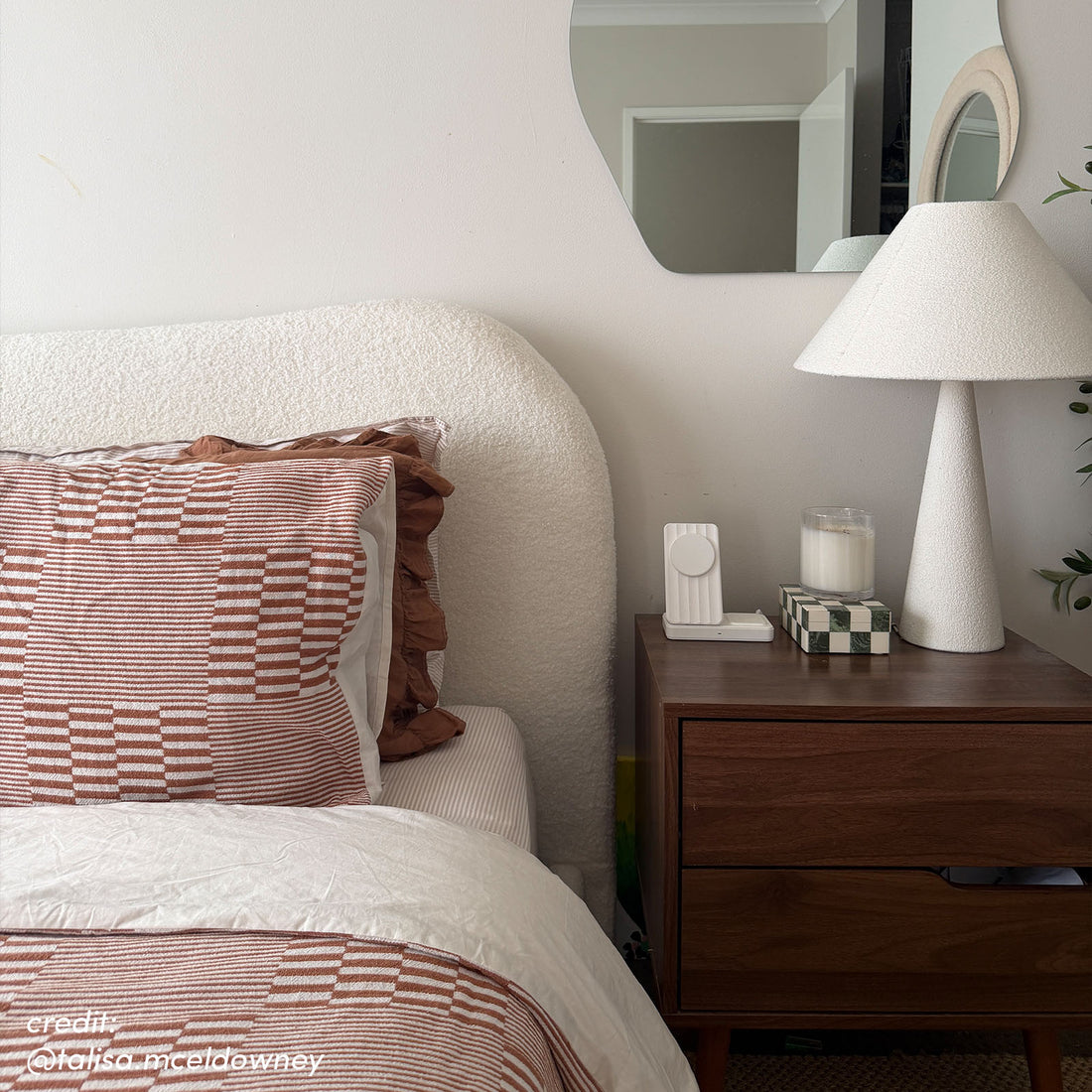 Ginnie Bouclé Curved King Bed Frame – Cream White, featuring a textured curved headboard and matching bedding with rust-toned