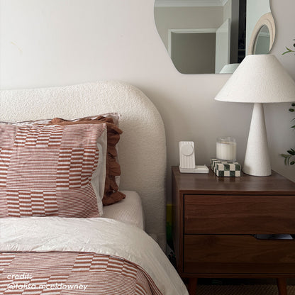 Ginnie Bouclé Curved King Bed Frame – Cream White, featuring a textured curved headboard and matching bedding with rust-toned