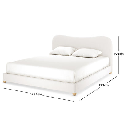 Ginnie Bouclé Bed & Oriona Mattress - King Cream features a plush curved headboard and luxurious texture, showcasing a close-up of the white pillow on the cream bed frame.