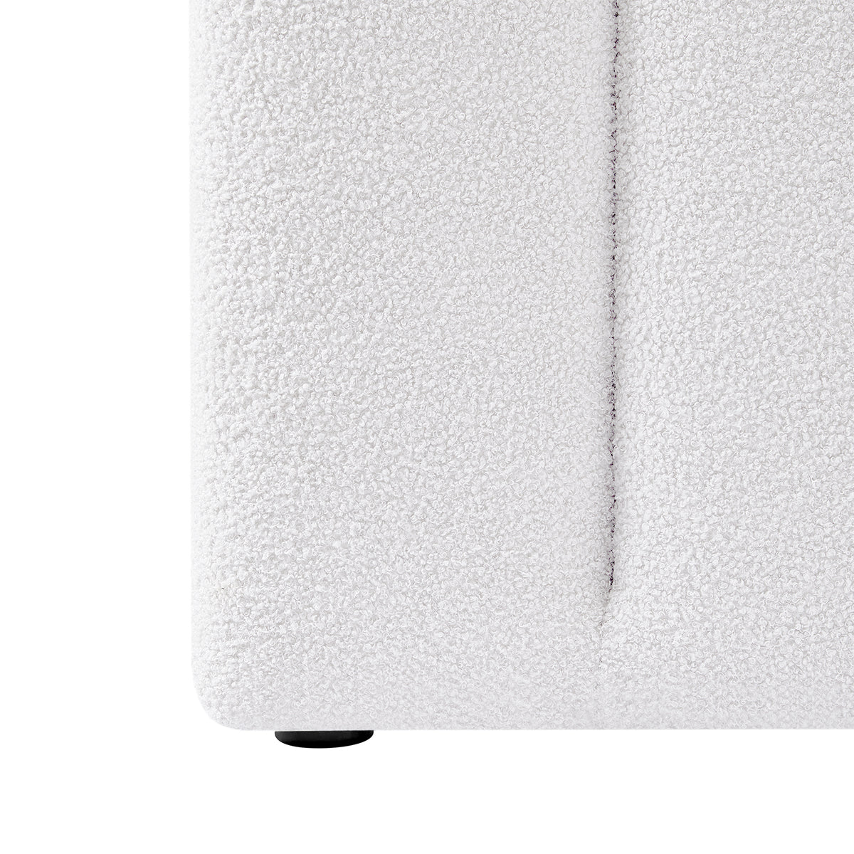 Close-up of the Aquila & Fabia Bed Package - Cream White King, showcasing the boucle-textured upholstery on the lower corner and a small round black foot, emphasizing luxury and style.