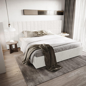 Aquila King Extra Wide Bouclé Headboard in Cream White, upholstered in soft textured fabric, complements a modern bedroom setting with white bedding, neutral pillows, and minimalist décor elements like side tables and lighting.