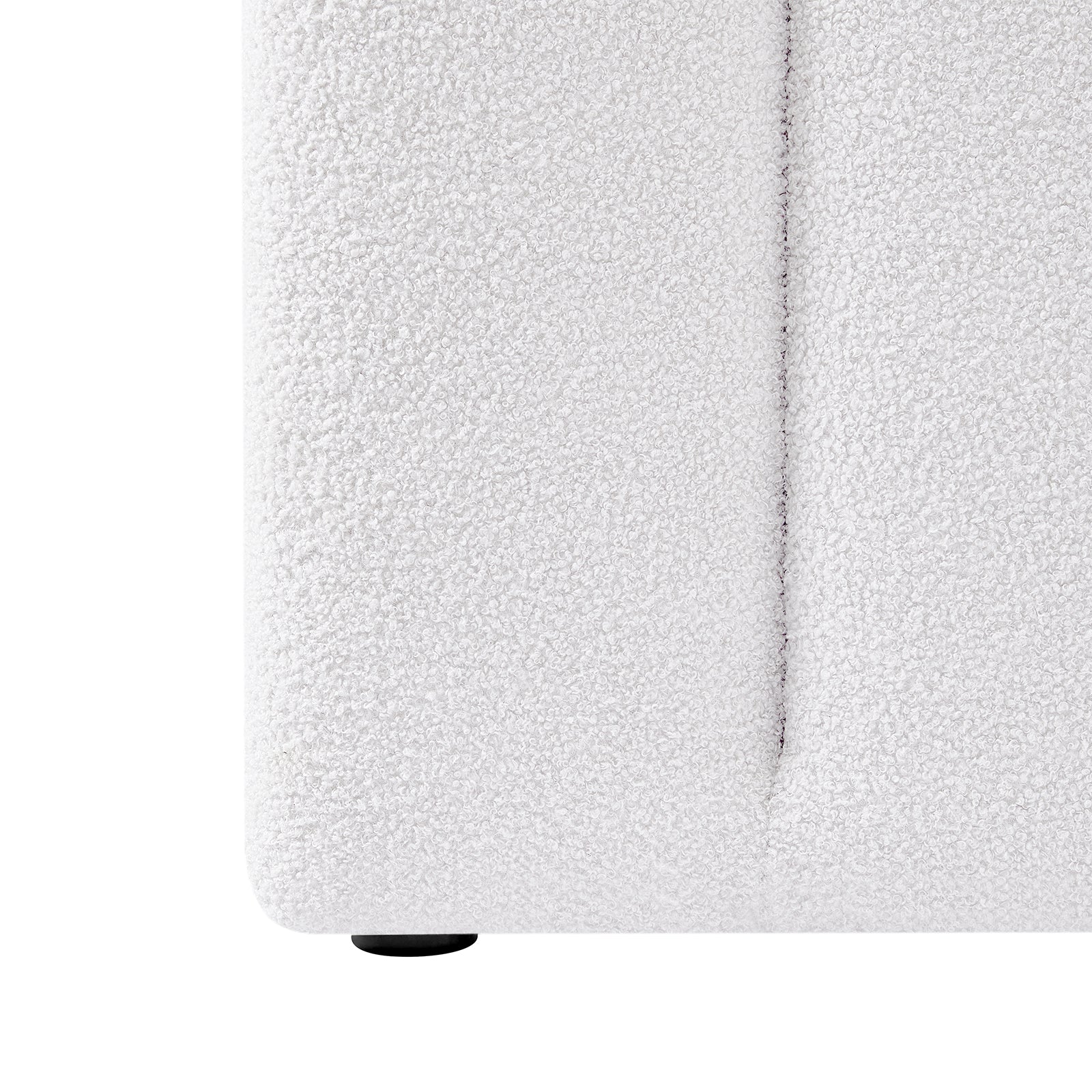 Close-up of the Aquila & Fabia Bed Package - Cream White Queen, showcasing the white bouclé fabric upholstery with a visible vertical seam and one small, round black foot at the bottom.