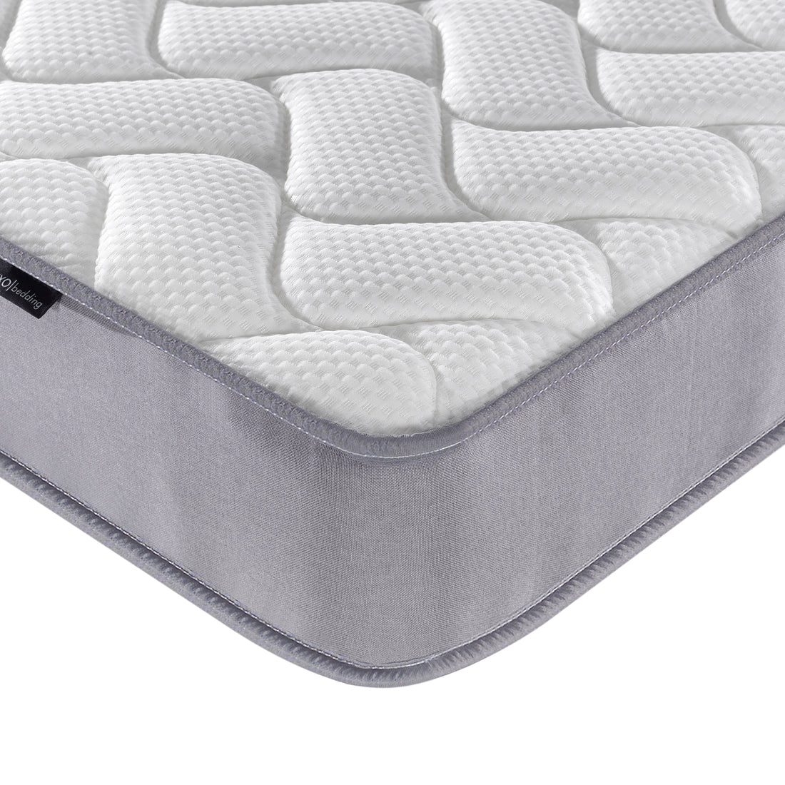 Harel & Vesta Slide Bunk Bed & Vesta Mattress Set in Natural, highlighting the quilted mattress pad's white, textured top and grey fabric side wall wrapping around the mattress corner.