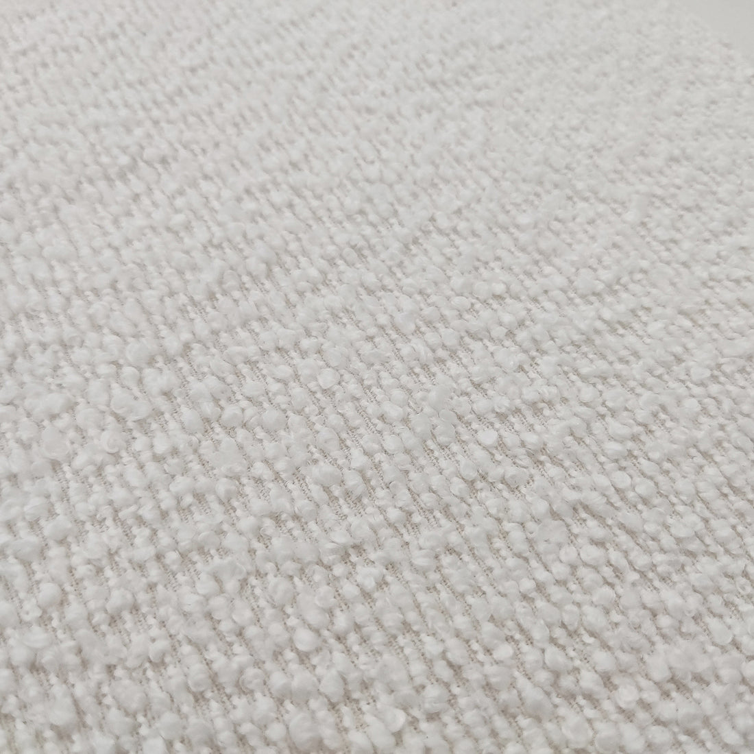 Close-up of the Harper Boucle King Bed Frame in eggshell white, showcasing its plush boucle upholstery and sturdy eucalyptus hardwood frame, highlighting the bed's modern sophistication and designer collaboration details.