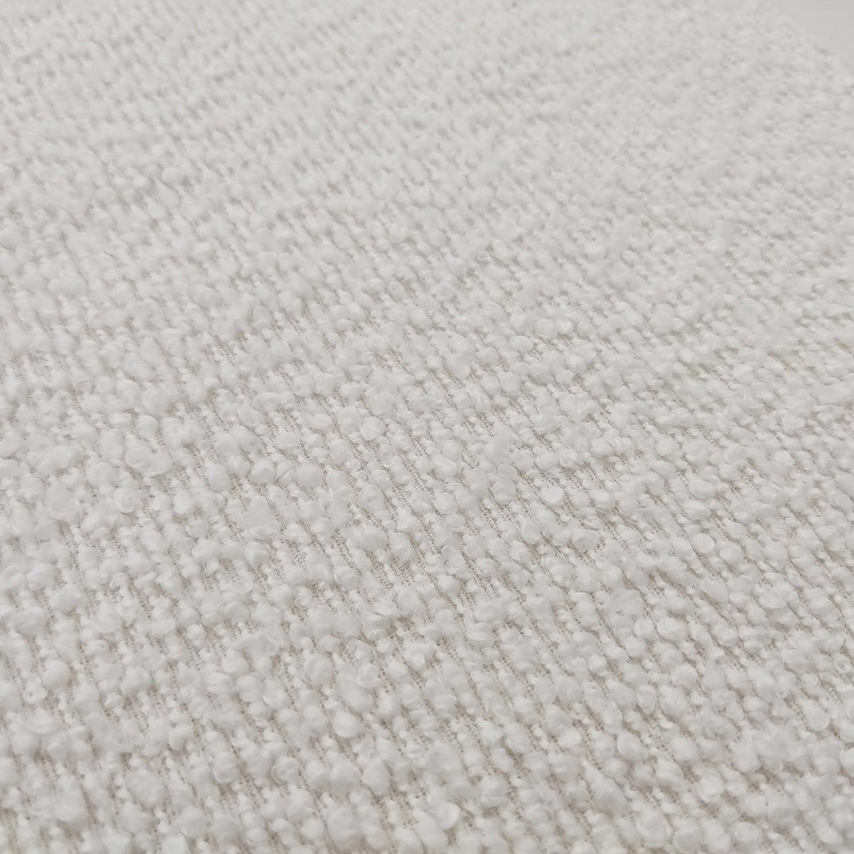 Close-up of the Harper Boucle King Bed Frame in eggshell white, showcasing its plush boucle upholstery and sturdy eucalyptus hardwood frame, highlighting the bed's modern sophistication and designer collaboration details.
