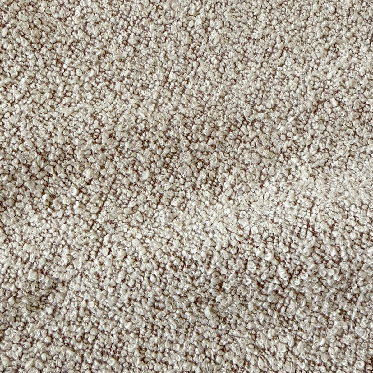 Close-up of warm beige boucle fabric texture with woven looped yarn pattern