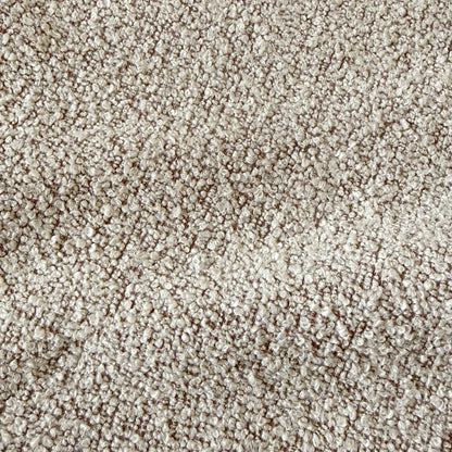 Close-up of warm beige textured fabric upholstery with woven pattern