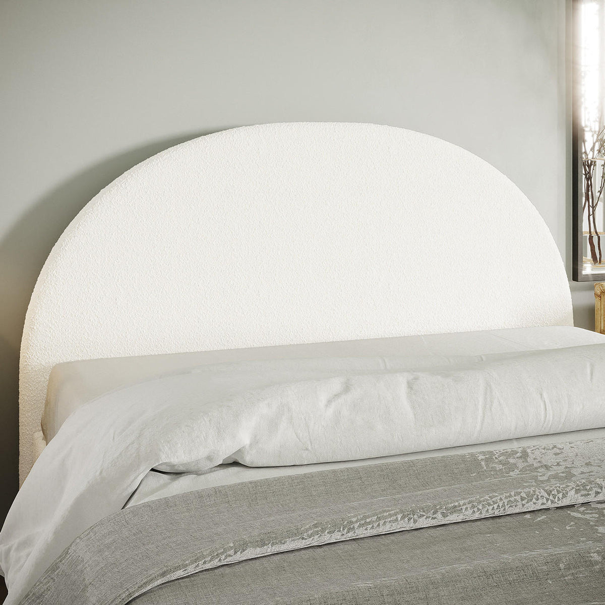 Florus Bouclé Queen Upholstered Round Bed Headboard - Cream White, featuring a textured, semicircular design against a pale gray wall, complemented by a light duvet and grayish throw.