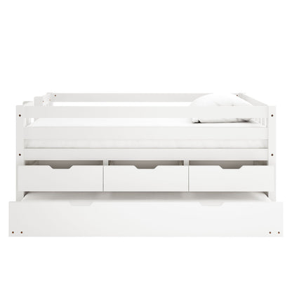 White wooden junior bed with safety rails, three storage drawers underneath and pull-out trundle drawer, shown with white