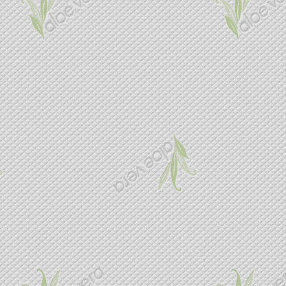 Close-up of white quilted mattress fabric with diagonal stitching pattern and green aloe vera leaf prints