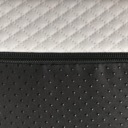 Close-up of white and black zippered mattress cover with geometric and dotted fabric patterns