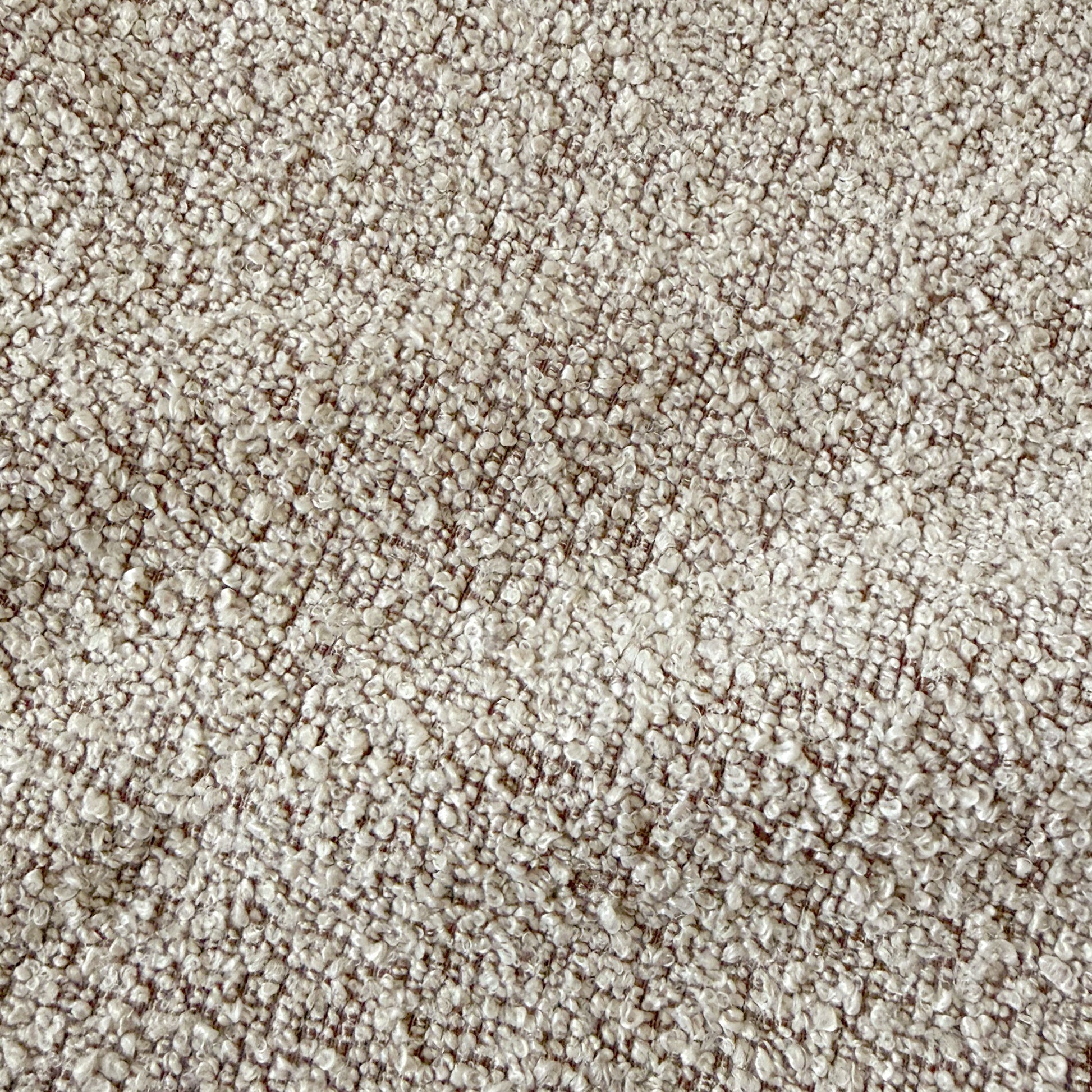 Close-up of beige boucle fabric texture showing woven looped yarn detail