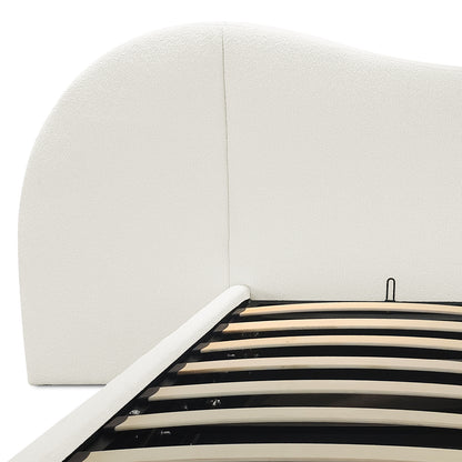 Close-up of cream white boucle upholstered curved headboard and gas lift slatted base