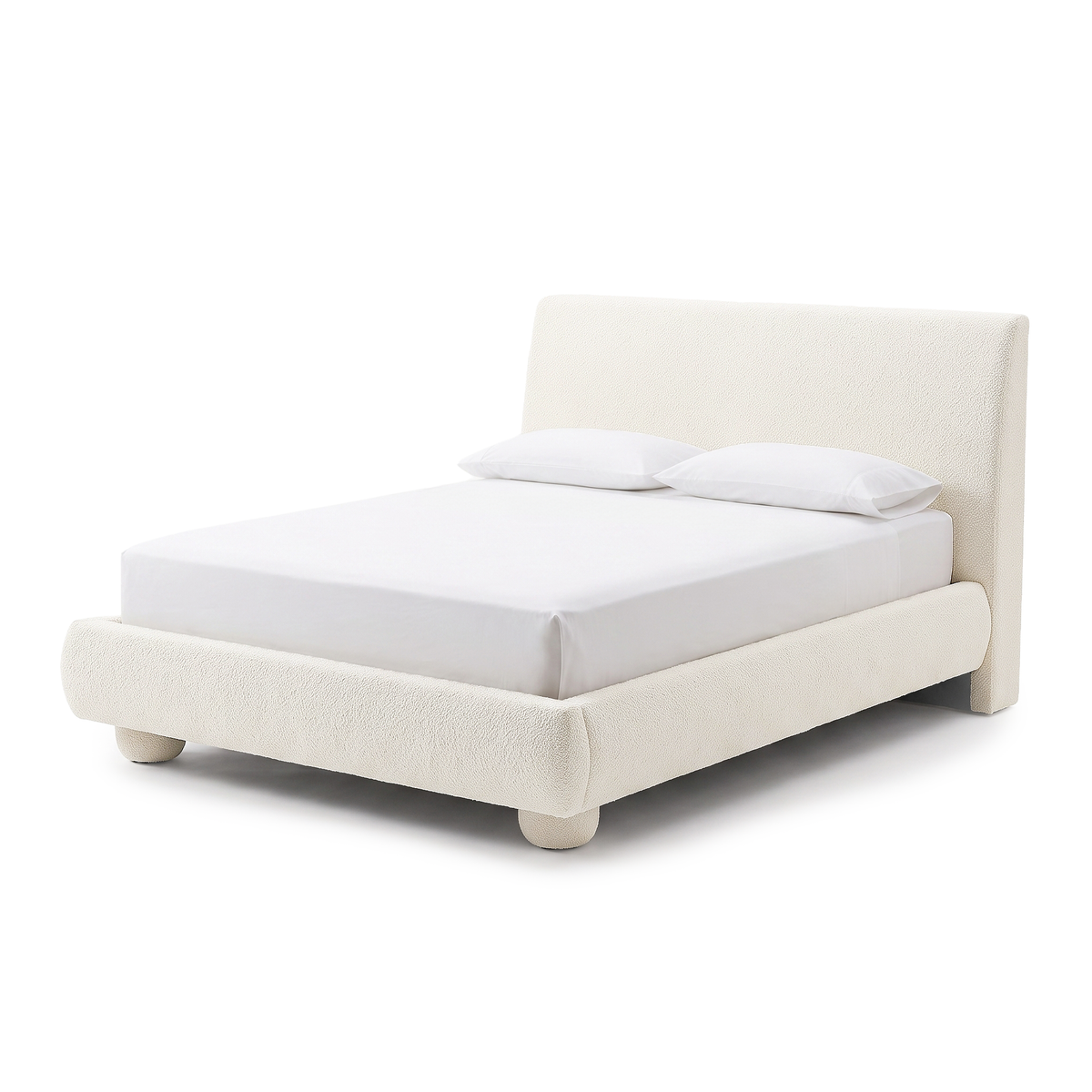 Modern upholstered bed on a white background with white bedding and pillows
