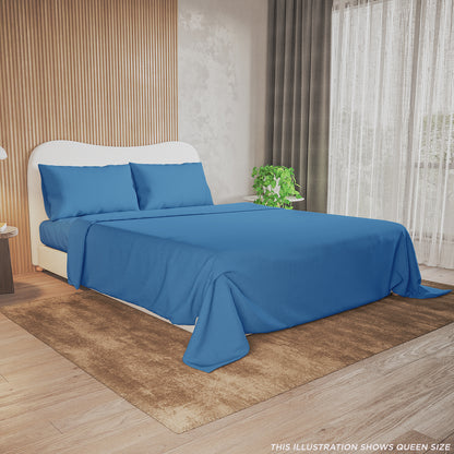 Valeria King Single 1000TC Ultra Soft Bed Sheet Set in Blue showcased on a queen-size bed with blue sheets, matching pillowcases, beside a potted plant, lamp, and books in a serene bedroom setting.