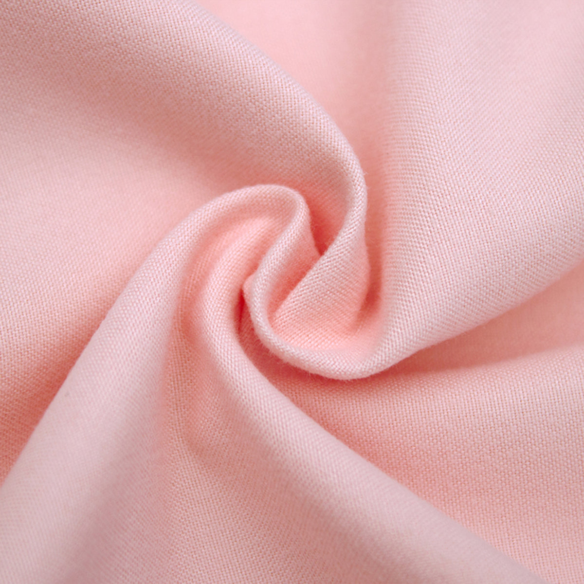 Close-up of blush pink 1000TC bed sheet fabric showing soft woven texture and gentle drape