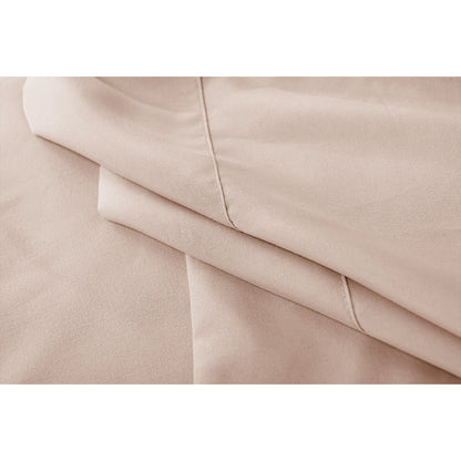 Close-up of cream bed sheet set showing folded edges and stitching detail
