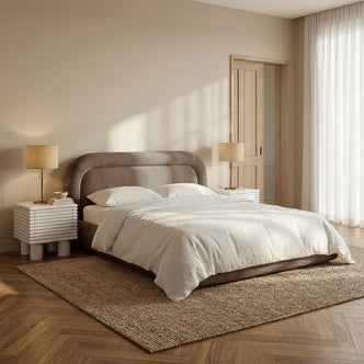 Mara King Velvet Gas Lift Storage Bed Frame in Taupe Brown with curved headboard, shown with white bedding on textured rug