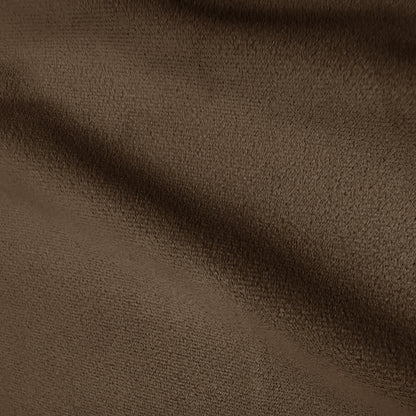Close-up of taupe brown velvet upholstery texture showing soft plush pile and subtle colour variation