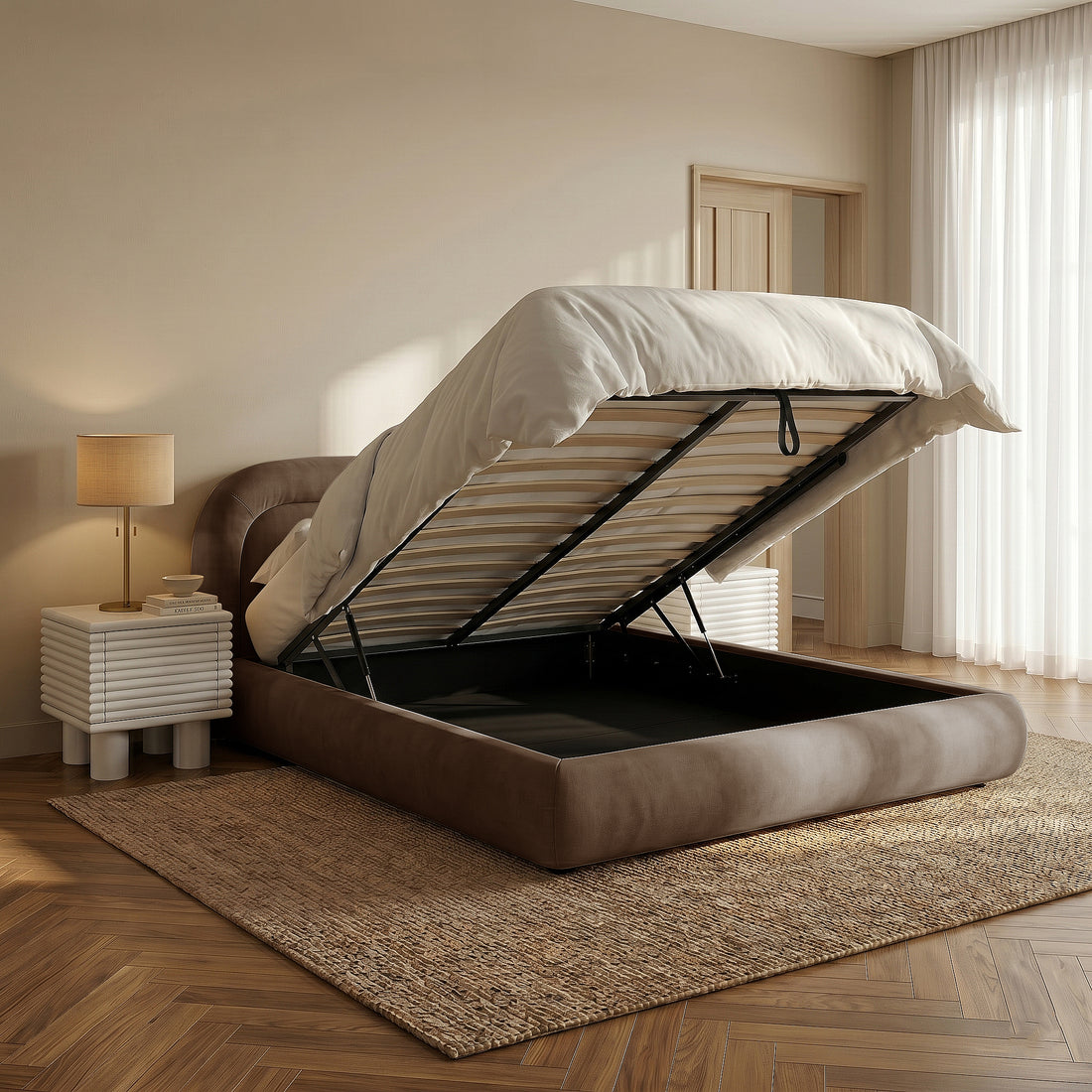 Mara Queen gas lift storage bed frame in taupe brown velvet with mattress base lifted, shown in bedroom with bedside table