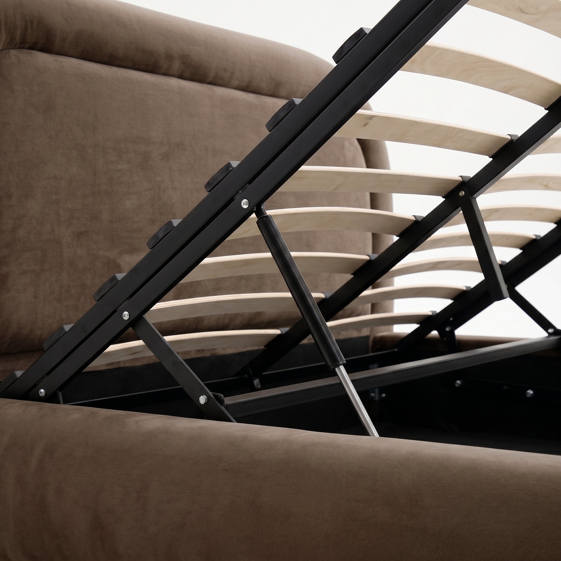 Close-up of the gas lift mechanism and wooden slats on the Mara Queen Storage Bed Frame in taupe brown velvet