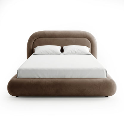 Taupe brown velvet queen bed frame with curved headboard, upholstered base, and white bedding