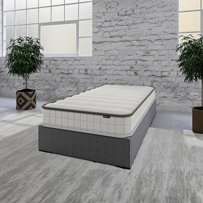 Cybele Single 20cm Pocket Spring Memory Foam Mattress on a dark grey platform with quilted top, highlighted in a minimalist industrial-style setting with potted plants and concrete flooring.