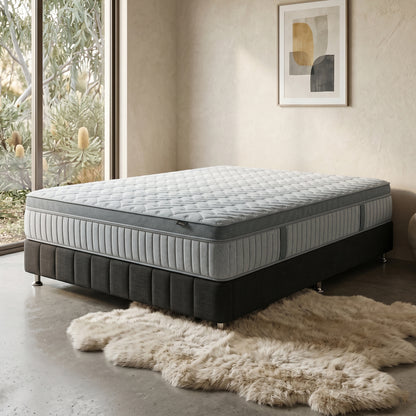 Layla pocket spring mattress styled on a black bed base with a fur rug.