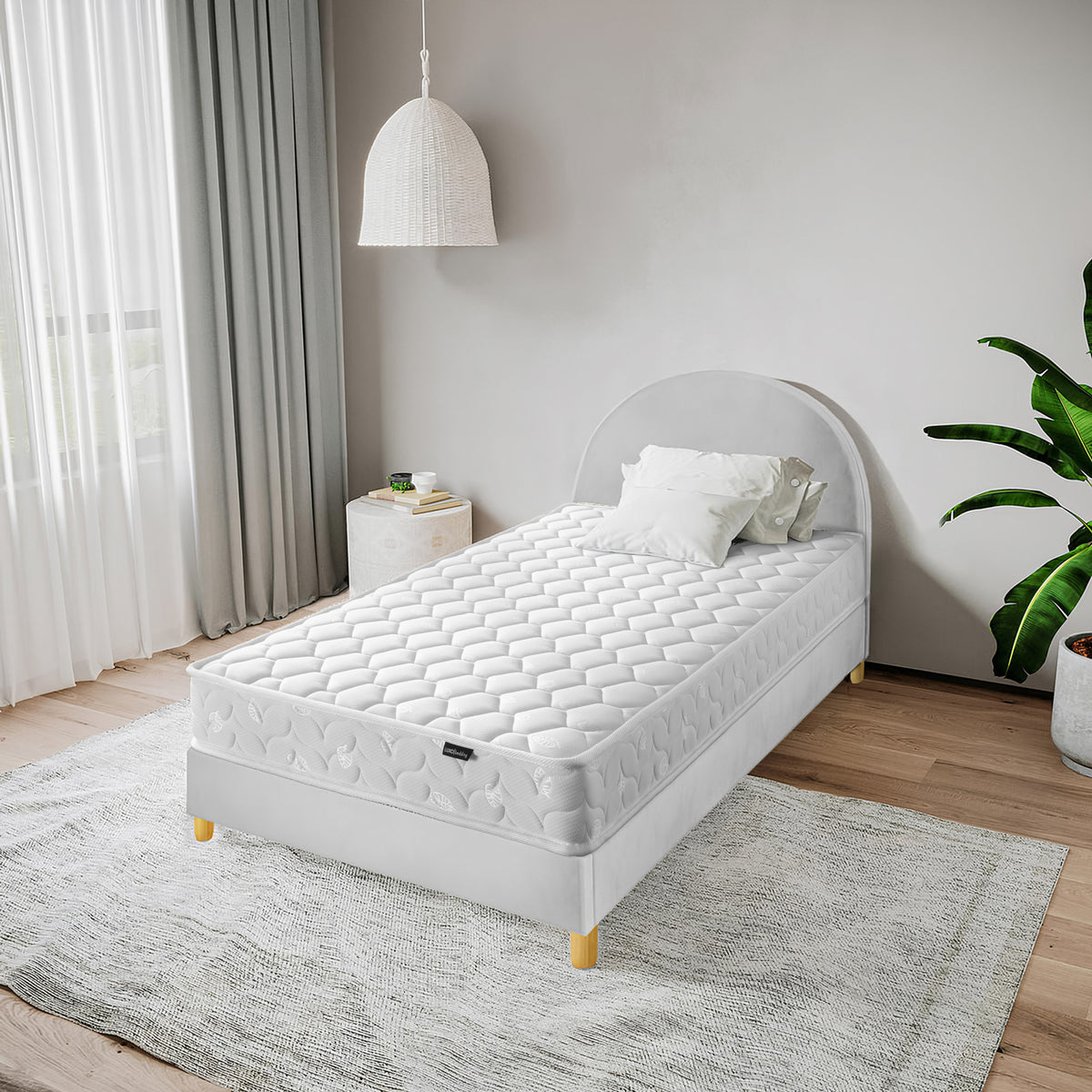 Thermis Single 15cm Hypoallergenic Mattress in Medium Firm on a white upholstered bed frame with wooden legs, featuring a