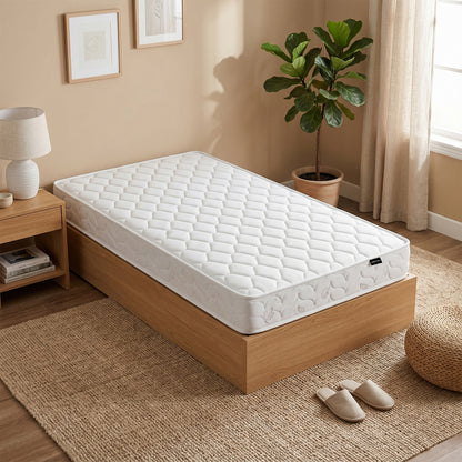 Thermis Single 15cm Hypoallergenic Mattress in Medium Firm on a wooden bed base in a bedroom with bedside table, lamp, plant